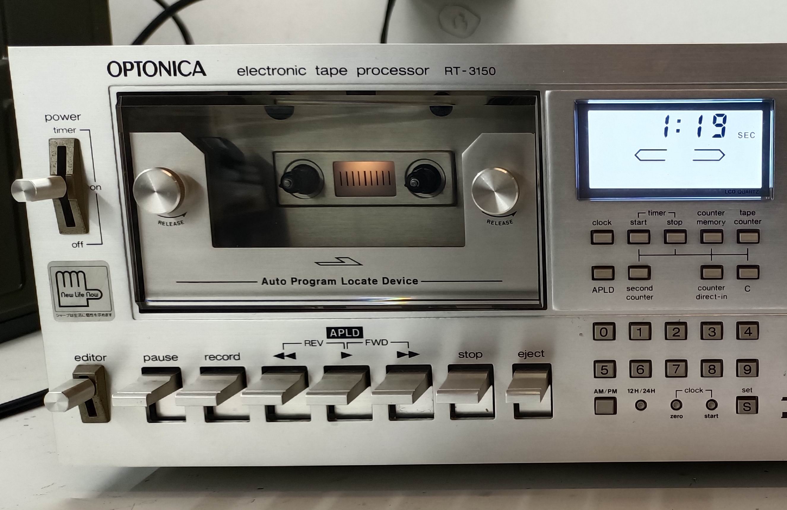 Sharp Optonica RT-3150 front panel, cassette loaded, blue display and silver control keys